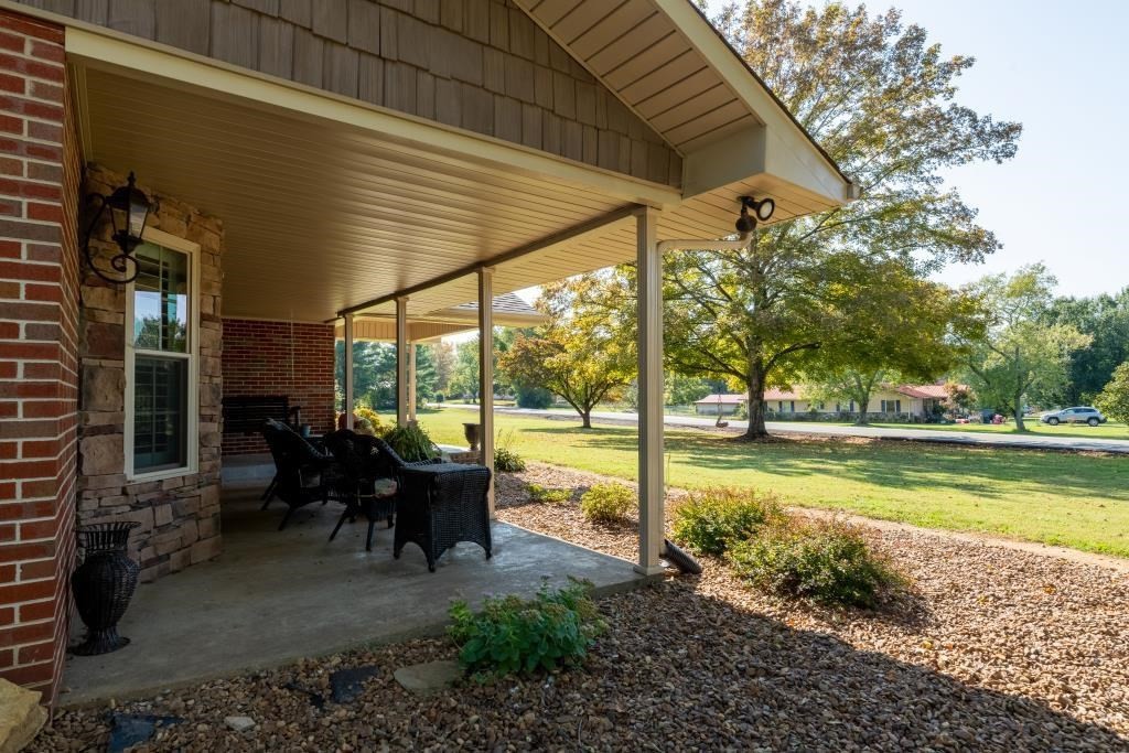1300 Main Street Decatur, TN 37322 - Photo 24 of 31 a view of a patio with chairs and floor to ceiling window next to a yard