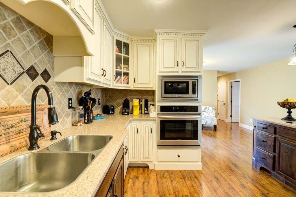 1300 Main Street Decatur, TN 37322 - Photo 10 of 31 a kitchen with a sink cabinets and wooden floor