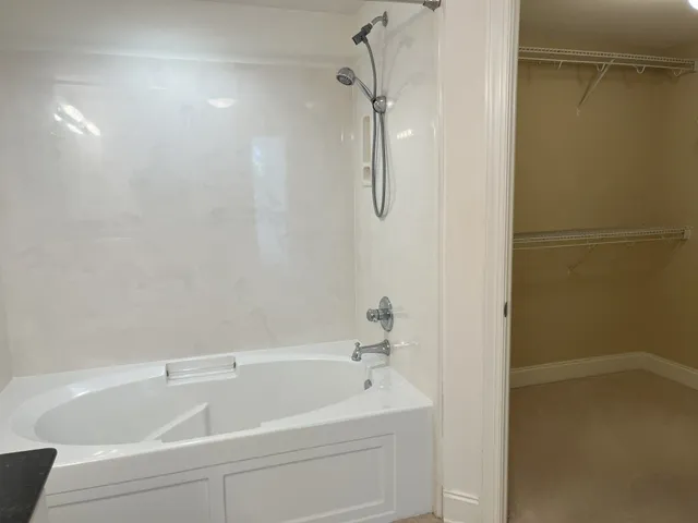 a bathroom with a granite countertop sink a toilet and a bathtub