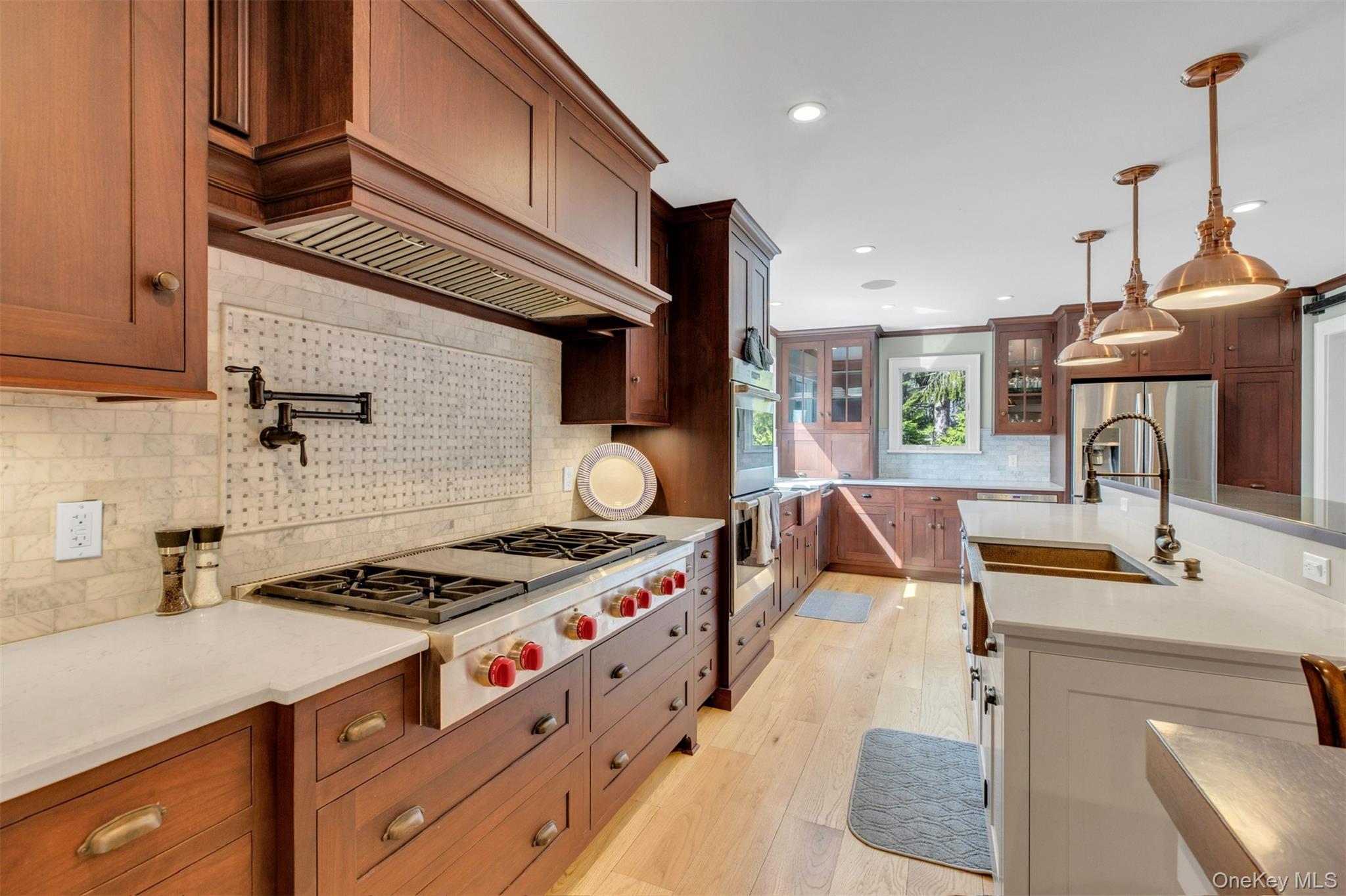 345 Colonial Road Southold, NY 11971 - Photo 10 of 43 a kitchen with stainless steel appliances granite countertop a sink stove and cabinets