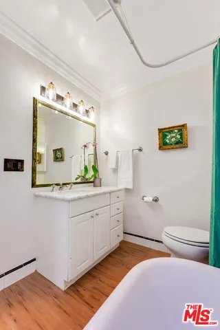a bathroom with a granite countertop sink mirror vanity and toilet