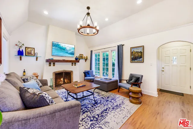 a living room with furniture a rug and a fireplace