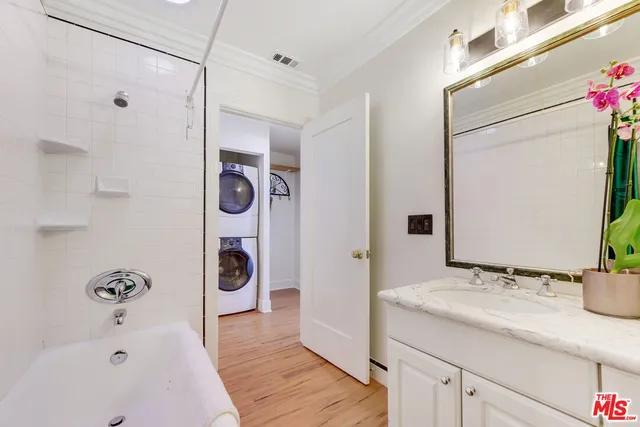 a bathroom with a tub sink and mirror
