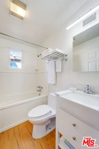 a bathroom with a sink a toilet and a bathtub