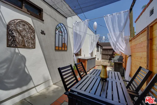 a view of outdoor living area with furniture and wooden floor