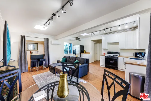 a living room with furniture dining table and a flat screen tv