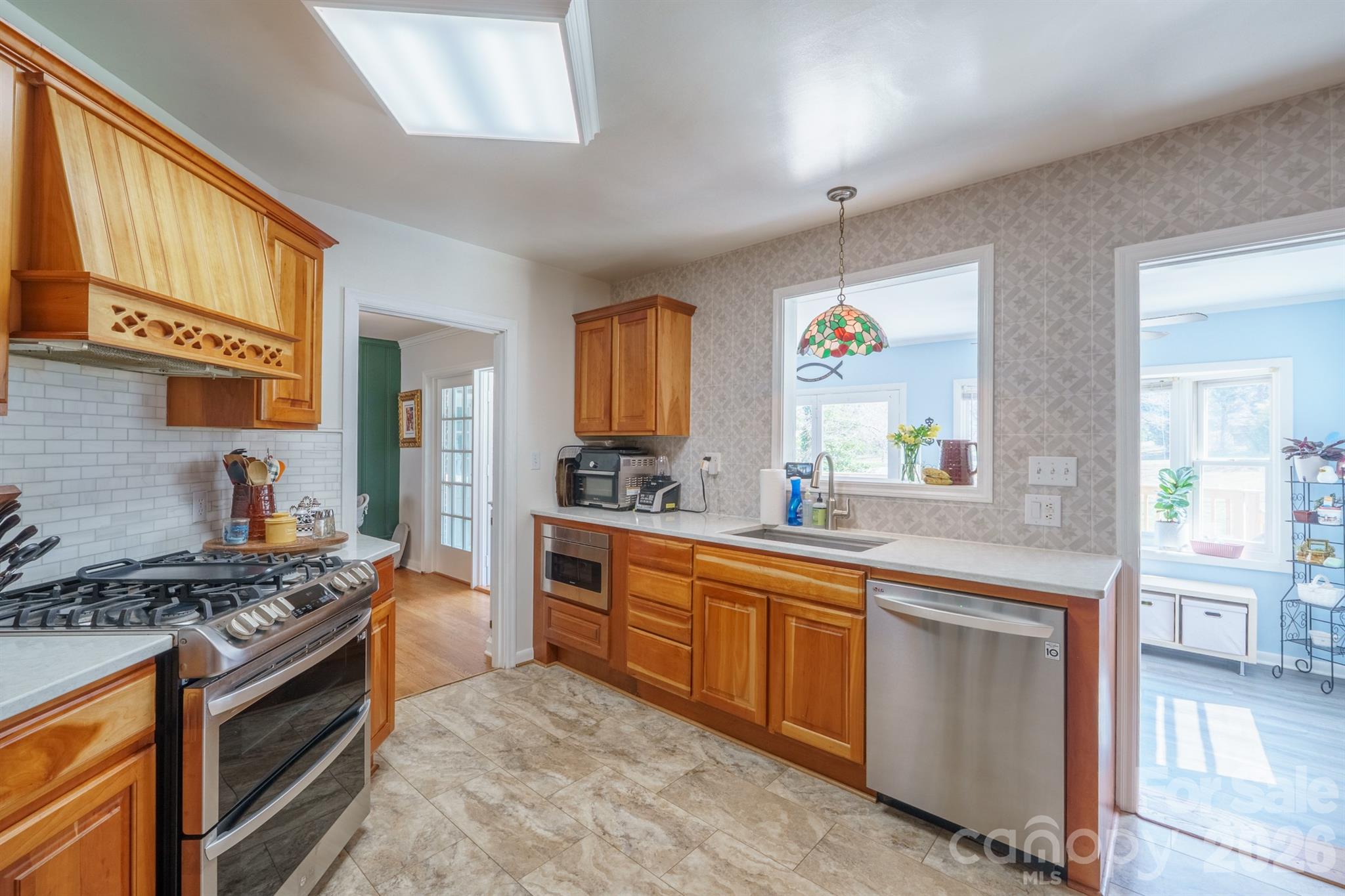 712 2nd Avenue Northwest Conover, NC 28613 - Photo 11 of 33 a kitchen with stainless steel appliances granite countertop a stove a sink and a refrigerator