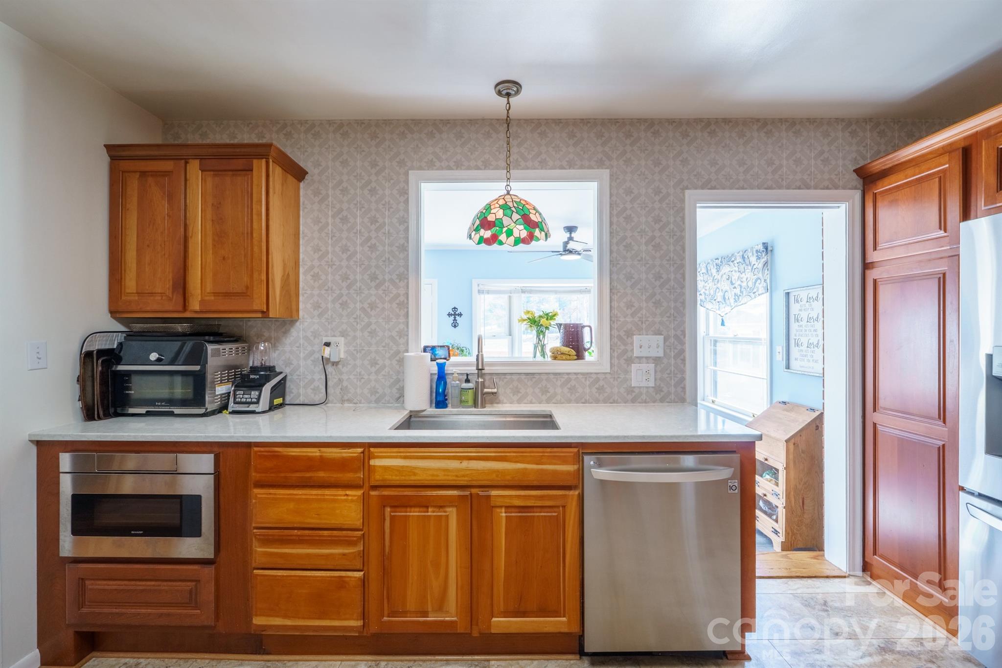 712 2nd Avenue Northwest Conover, NC 28613 - Photo 13 of 33 a kitchen with stainless steel appliances granite countertop a sink a stove and a wooden cabinets