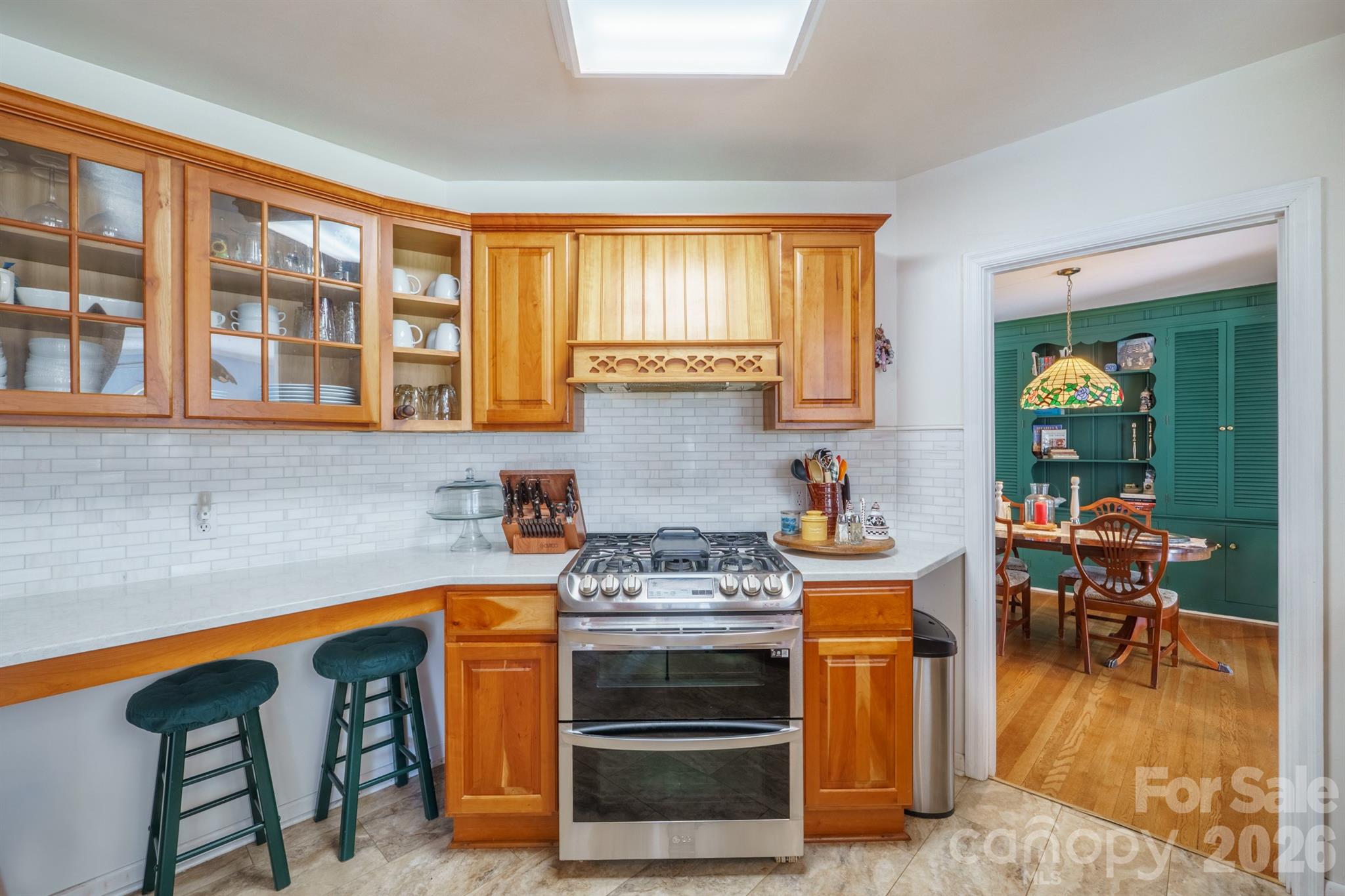 712 2nd Avenue Northwest Conover, NC 28613 - Photo 14 of 33 a kitchen with a stove and a wooden cabinets