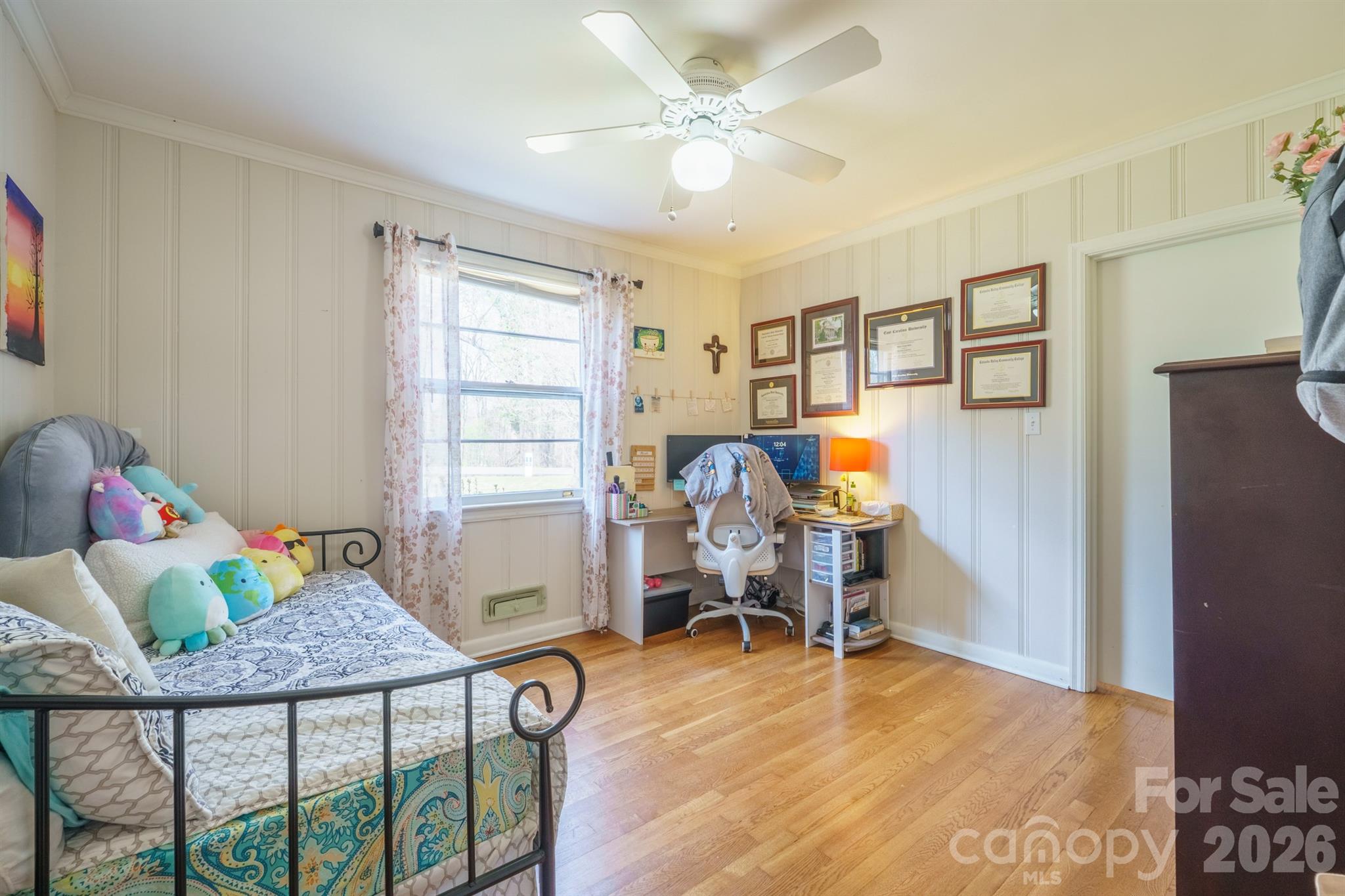 712 2nd Avenue Northwest Conover, NC 28613 - Photo 22 of 33 a bedroom with furniture and a wooden floor