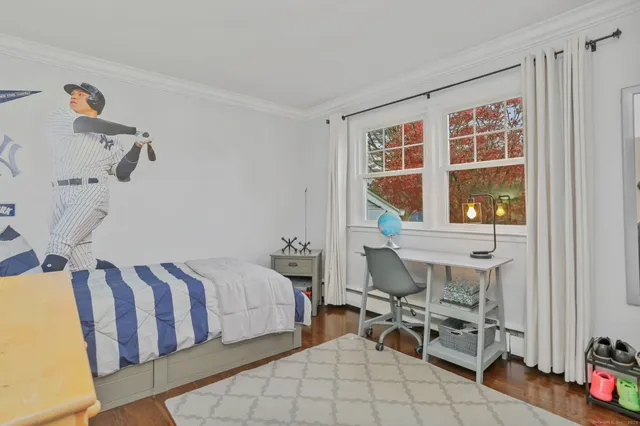 a bathroom with a granite countertop sink a toilet and mirror