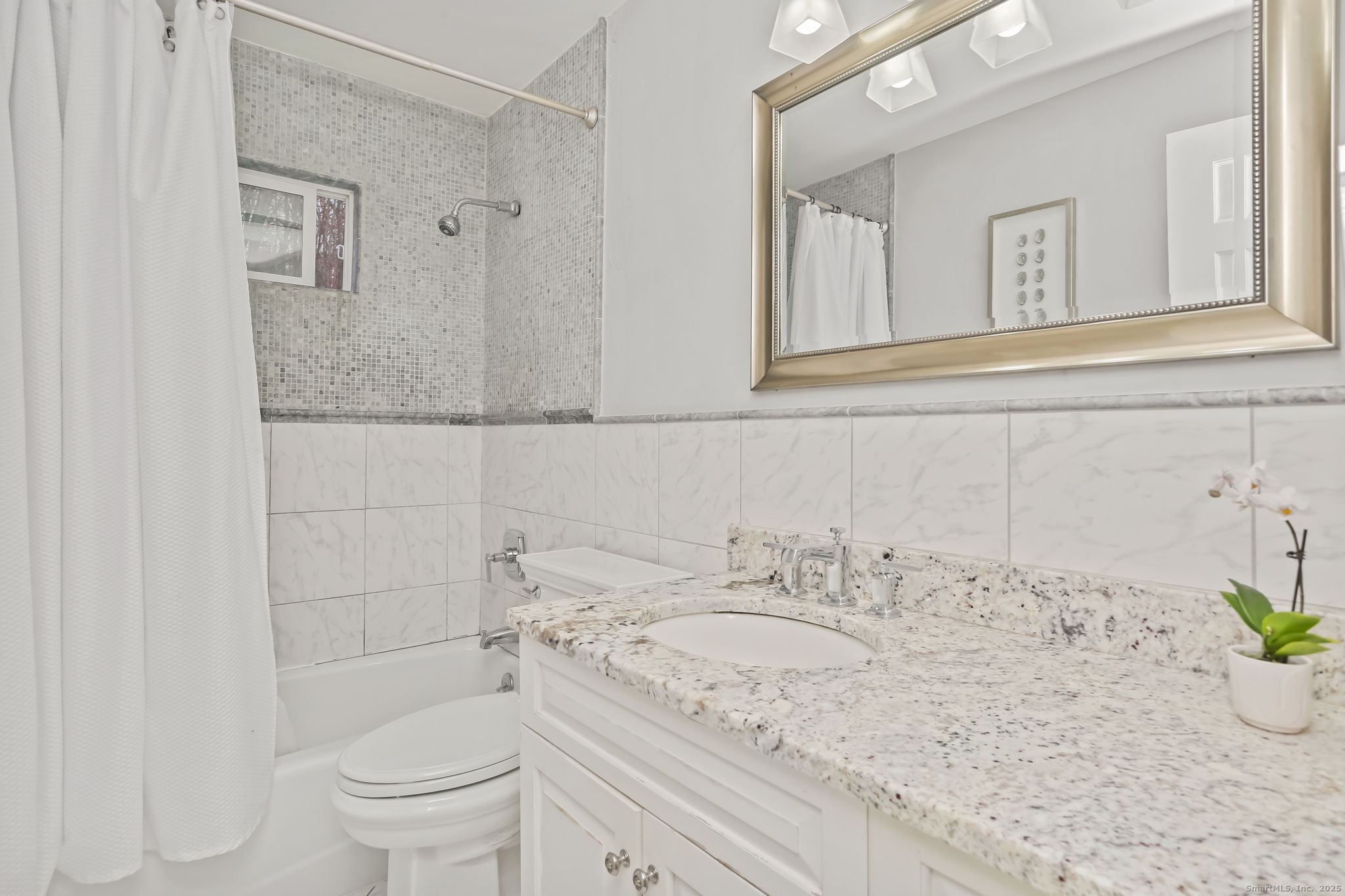 24 Warnock Drive Westport, CT 06880 - Photo 16 of 31 a bathroom with a granite countertop sink a toilet and mirror