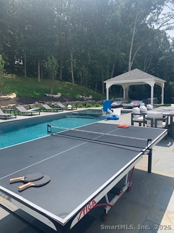 24 Warnock Drive Westport, CT 06880 - Photo 28 of 31 a backyard of a house with table and chairs