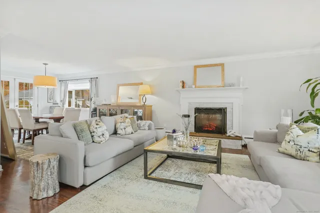 a living room with furniture a rug and a fireplace