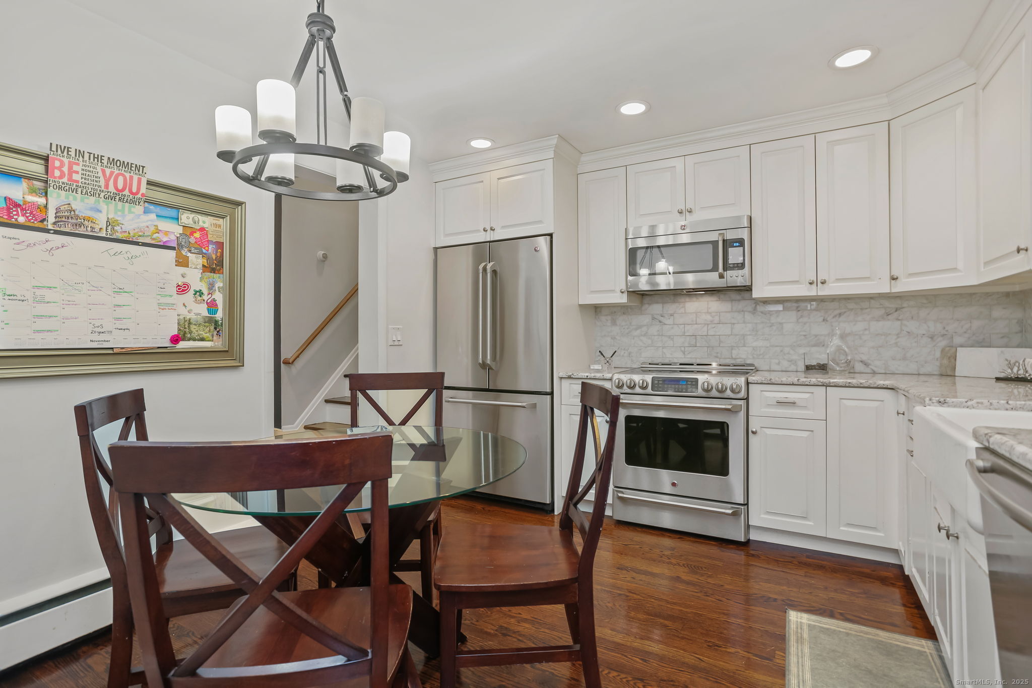 24 Warnock Drive Westport, CT 06880 - Photo 9 of 31 a kitchen with stainless steel appliances a dining table chairs and cabinets