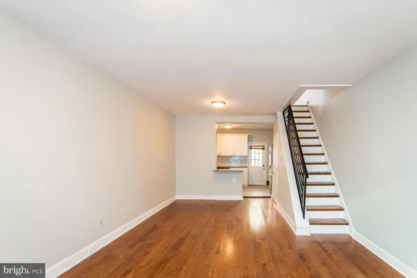 a view of wooden floor and windows in a room