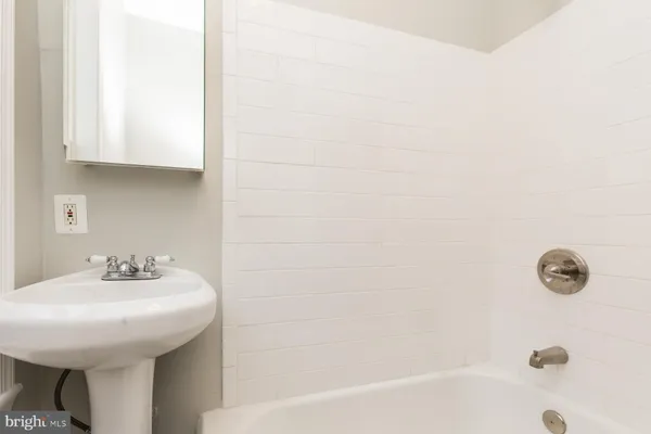 a bathroom with a sink a mirror and shower