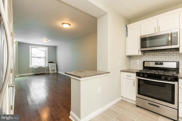 a kitchen with a stove and a microwave