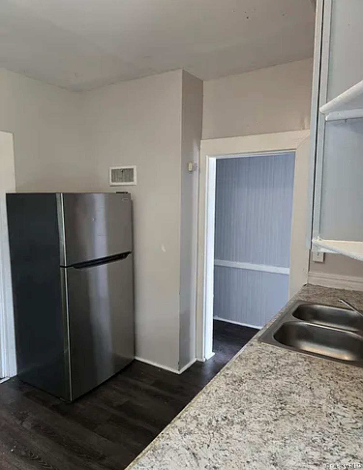 146 Mansion Street, Unit 2 Poughkeepsie, NY 12601 - Photo 3 of 14 a kitchen with a refrigerator and a stove top oven