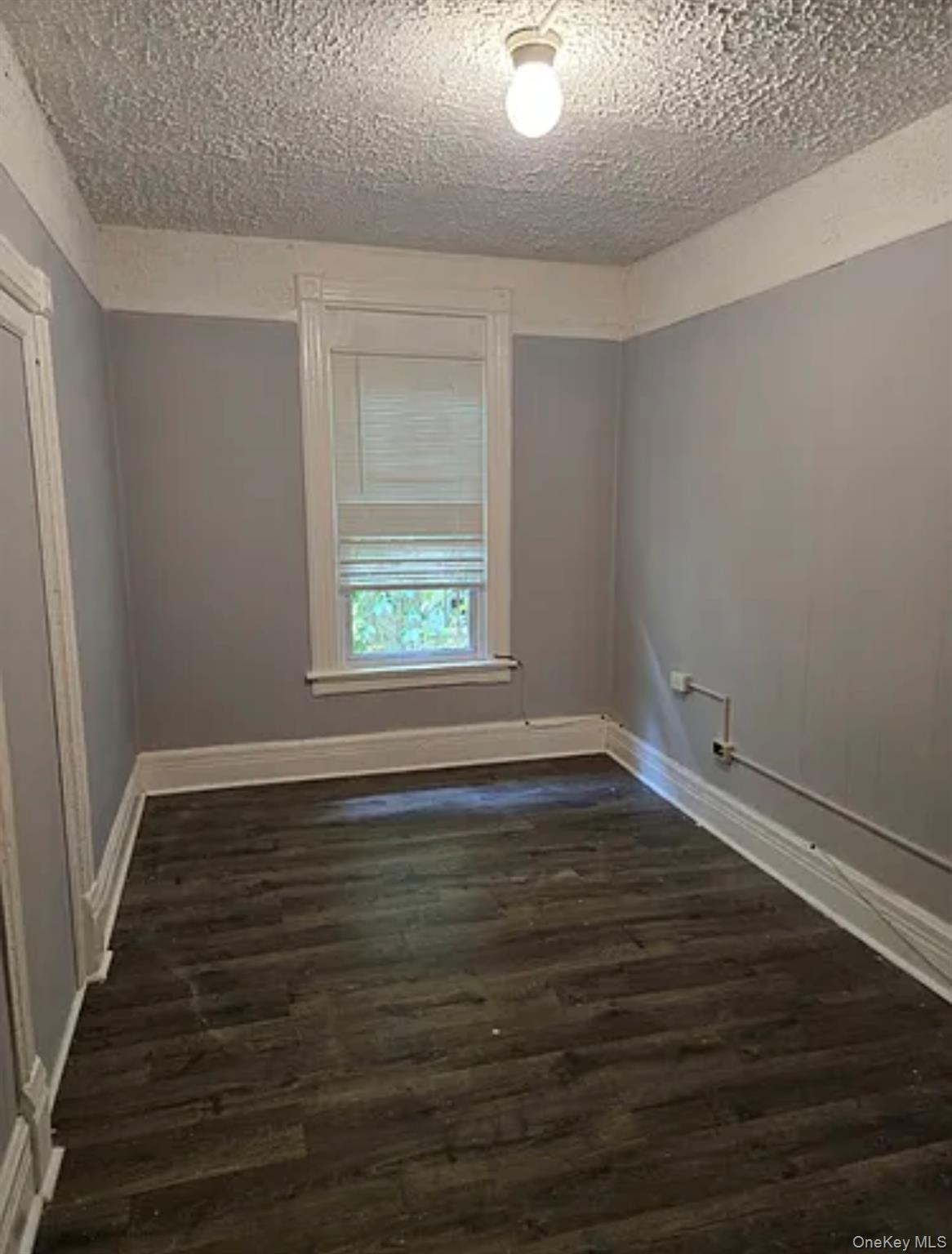 146 Mansion Street, Unit 2 Poughkeepsie, NY 12601 - Photo 5 of 14 a view of an empty room with wooden floor and a window