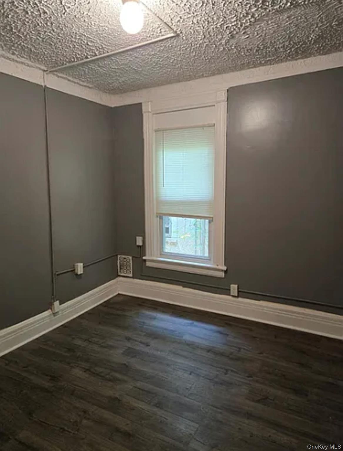 146 Mansion Street, Unit 2 Poughkeepsie, NY 12601 - Photo 8 of 14 a view of an empty room with wooden floor and a window