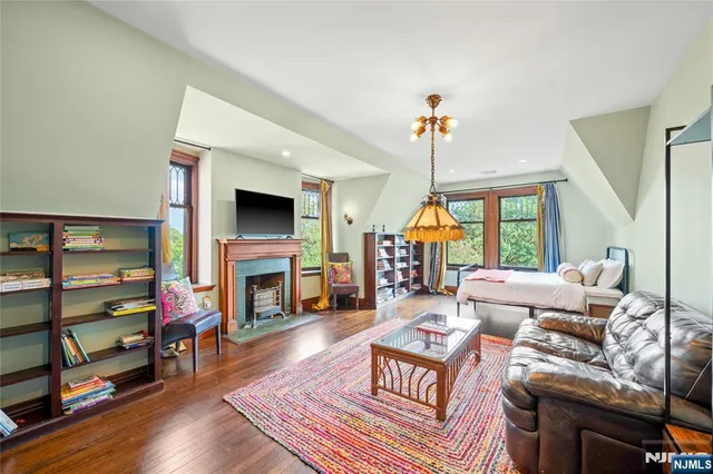 a view of a livingroom with a fireplace and window