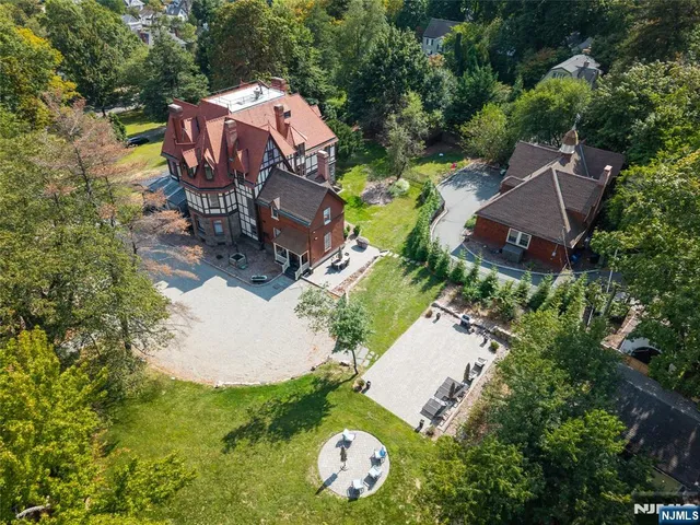 an aerial view of a house with a garden and lake view