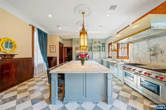 a kitchen with stainless steel appliances granite countertop a stove a sink dishwasher and cabinets with wooden floor
