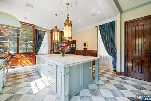 a kitchen with stainless steel appliances granite countertop a sink and a refrigerator