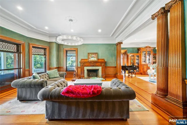 a living room with furniture a rug and a large window
