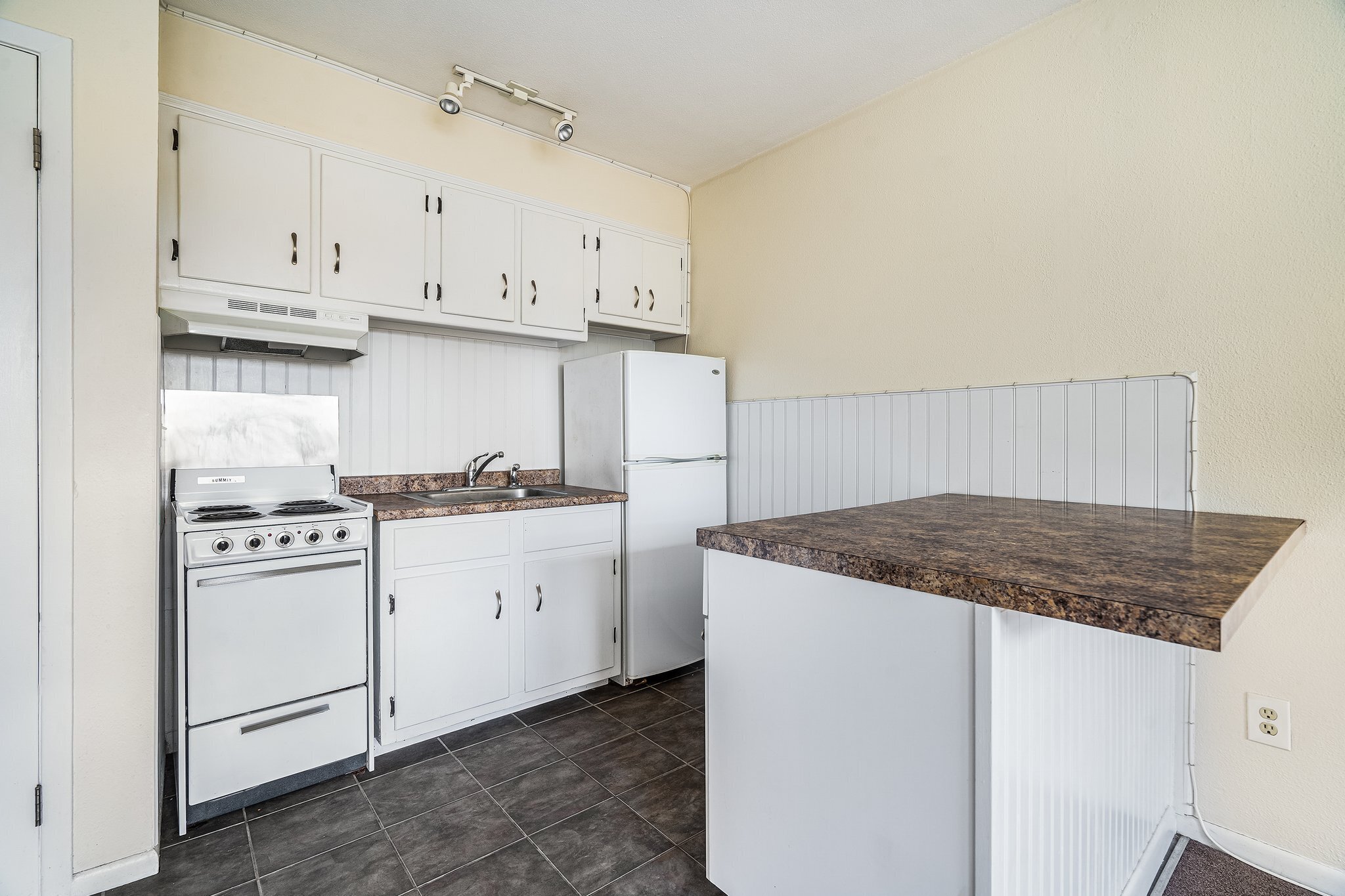 18 Fairfield Avenue, Unit A7 Norwalk, CT 06854 - Photo 4 of 11 a kitchen with granite countertop white cabinets and white appliances