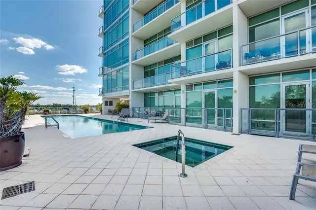 a swimming pool with outdoor seating