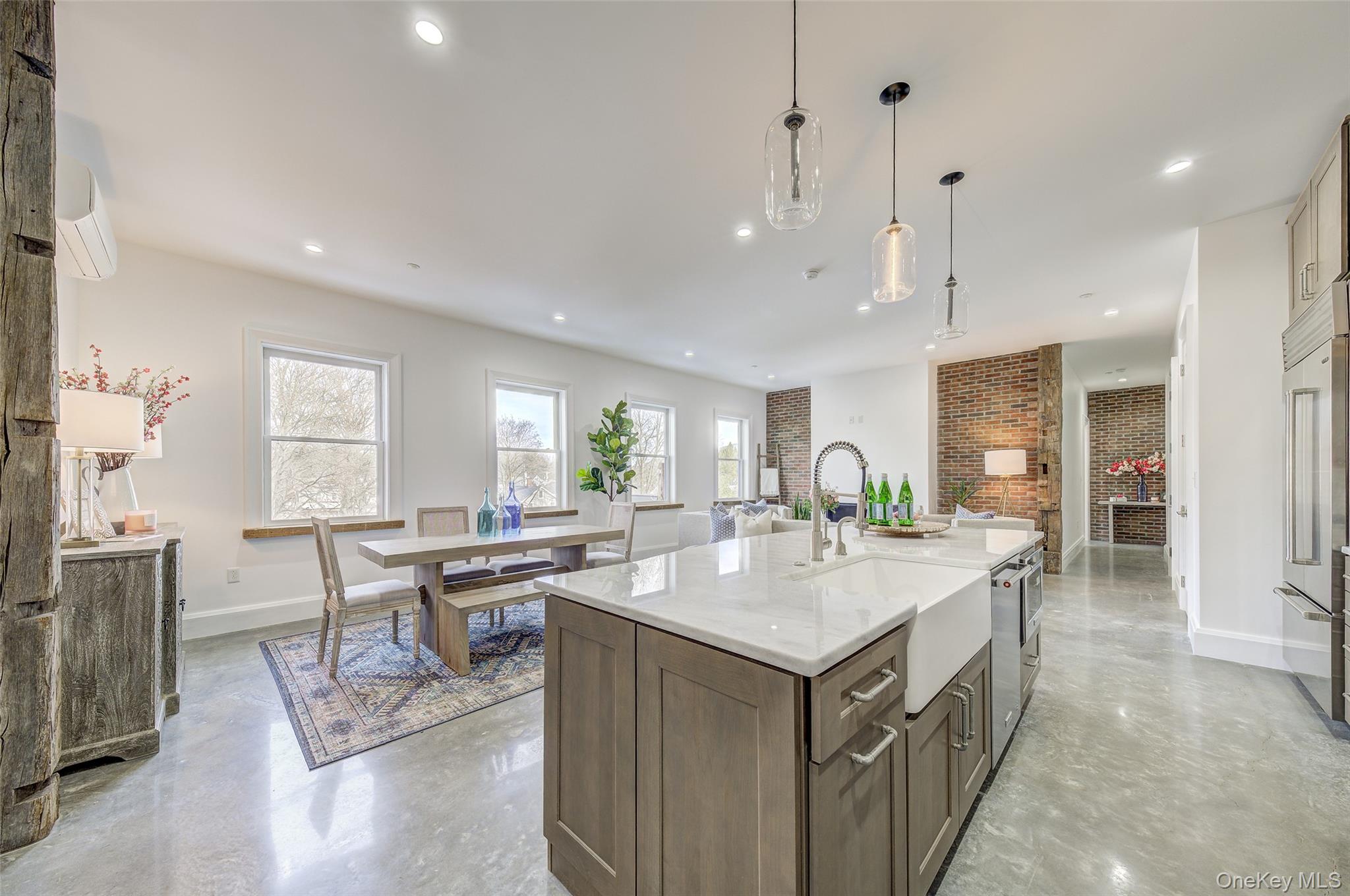 226 Main Street, Unit 302 Beacon, NY 12508 - Photo 16 of 43 Kitchen featuring finished concrete flooring, recessed lighting, pendant lighting, a center island with sink, and a wall mounted air conditioner