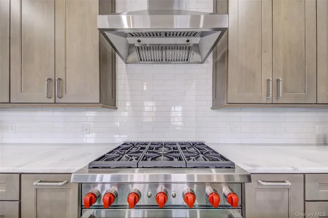 a kitchen with a stove and cabinets