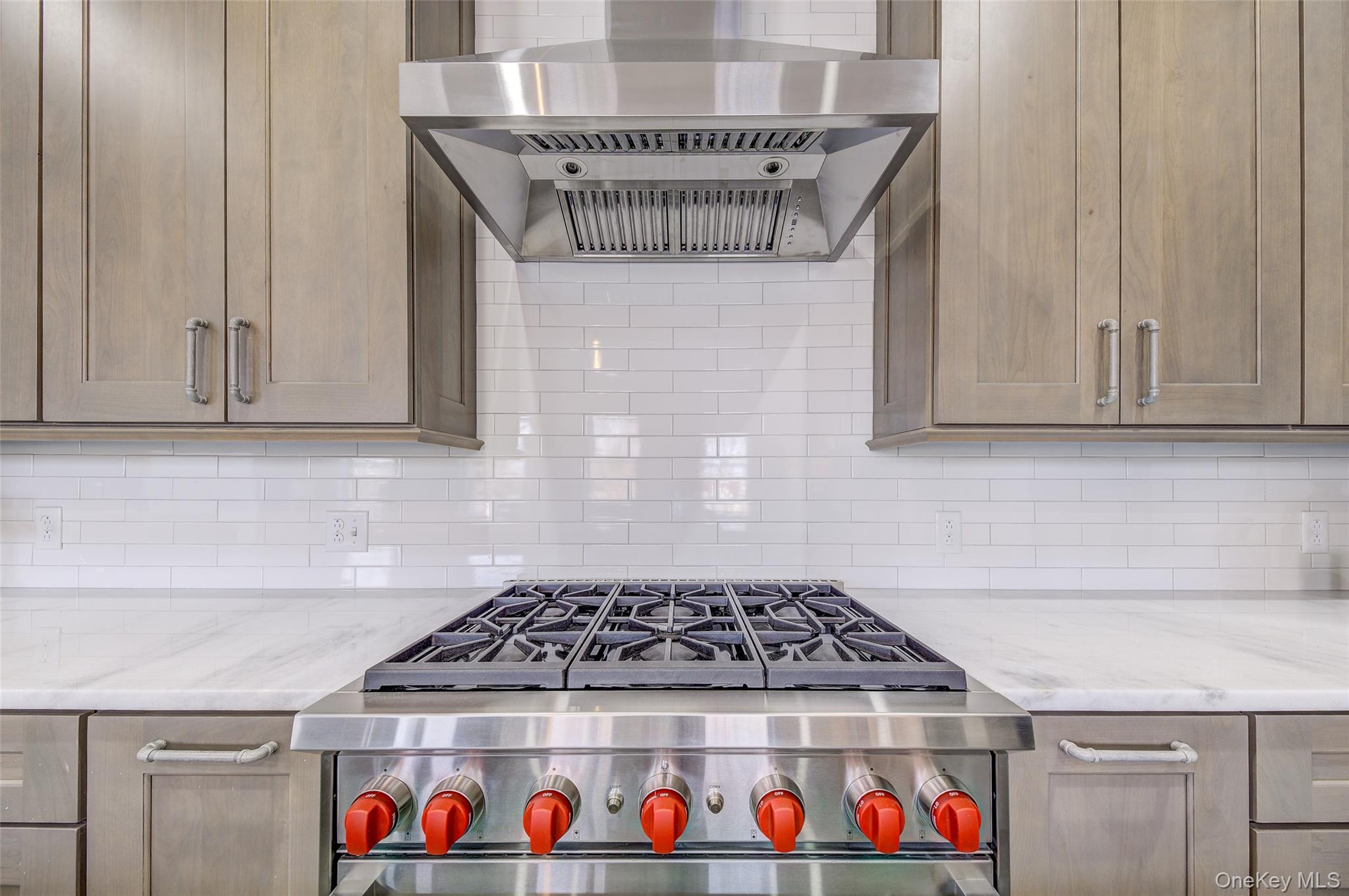226 Main Street, Unit 302 Beacon, NY 12508 - Photo 17 of 43 Kitchen with wall chimney range hood, high end stove, backsplash, and light stone counters