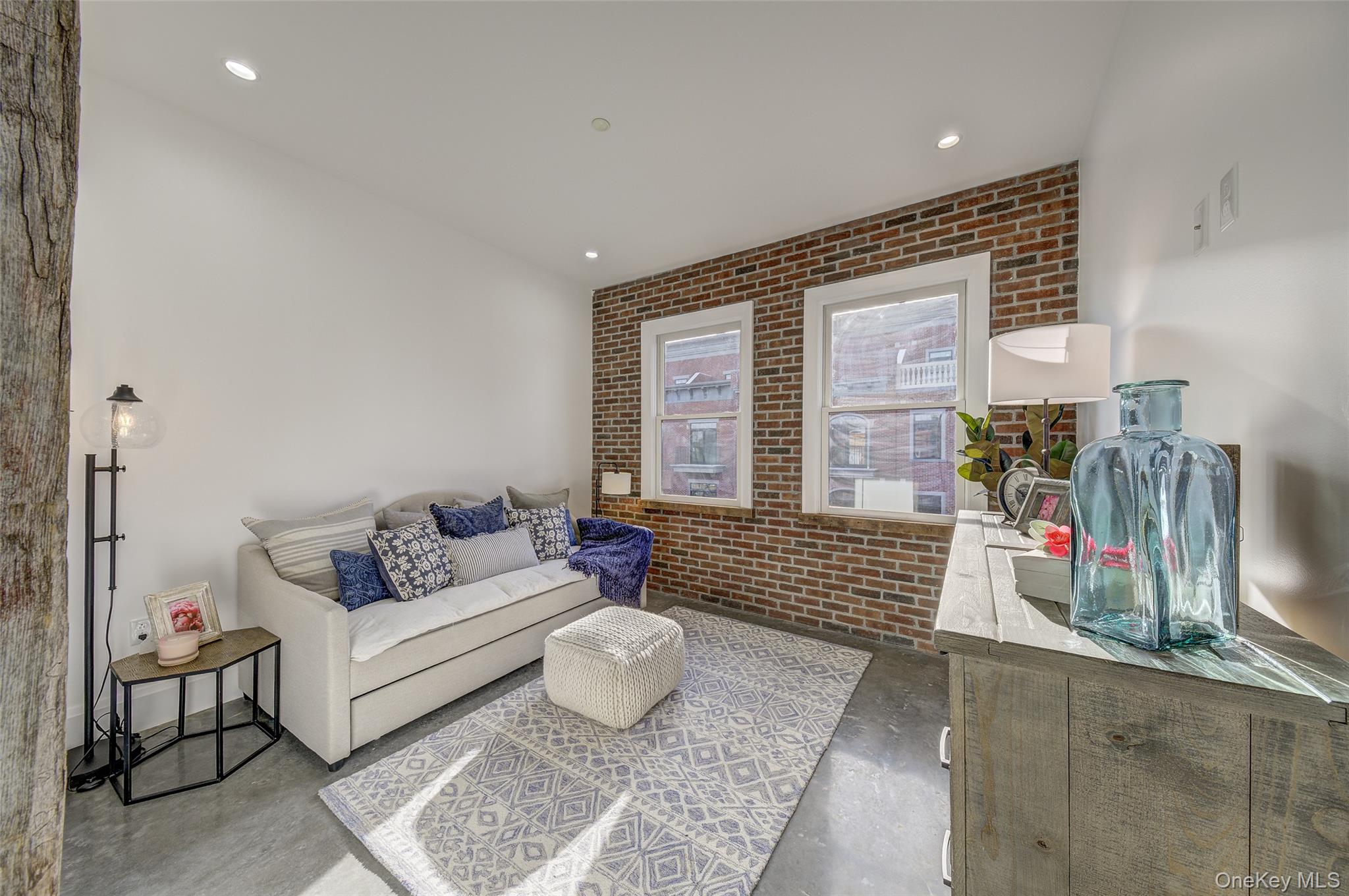 226 Main Street, Unit 302 Beacon, NY 12508 - Photo 22 of 43 Living room featuring concrete floors, brick wall, and recessed lighting