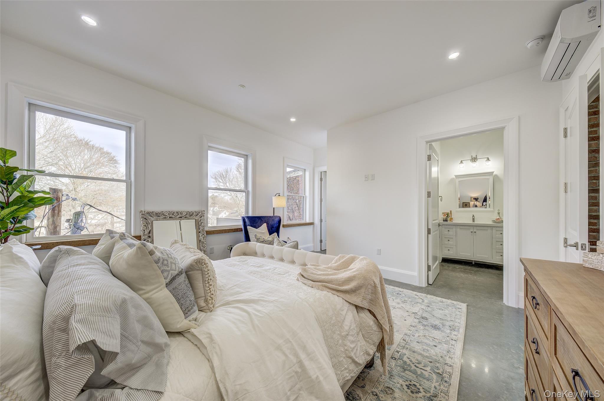 226 Main Street, Unit 302 Beacon, NY 12508 - Photo 30 of 43 Bedroom with a wall unit AC, concrete flooring, recessed lighting, and ensuite bath