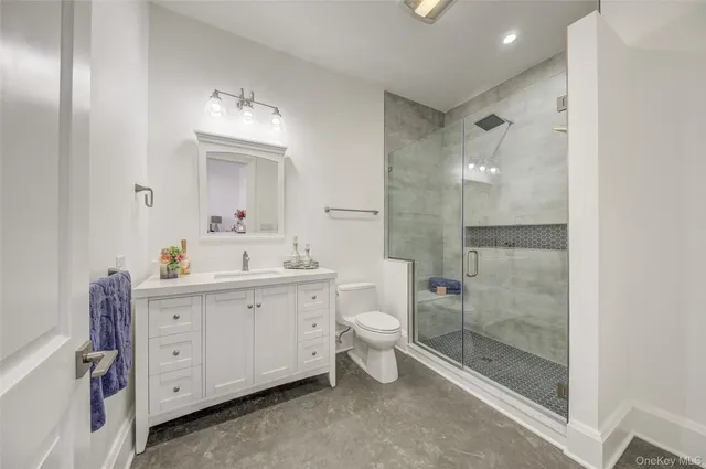 a spacious bathroom with a double vanity sink mirror and shower