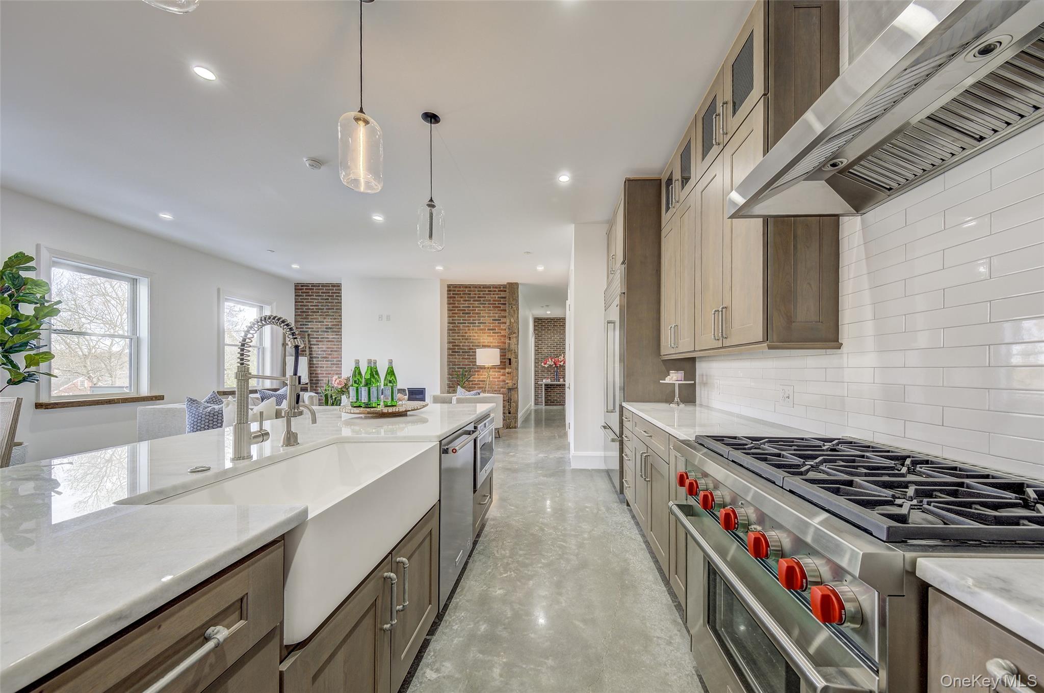 226 Main Street, Unit 302 Beacon, NY 12508 - Photo 37 of 43 Kitchen featuring stainless steel appliances, wall chimney exhaust hood, backsplash, recessed lighting, and glass insert cabinets