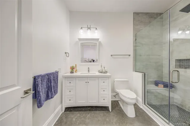 a spacious bedroom with a bed and a couch