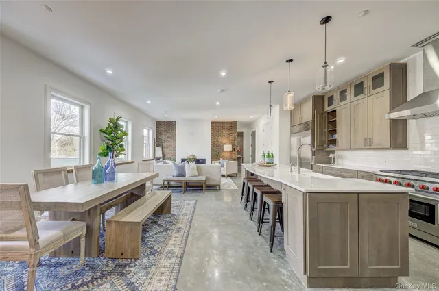 a large kitchen with a table and chairs
