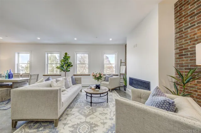 a living room with furniture and a potted plant