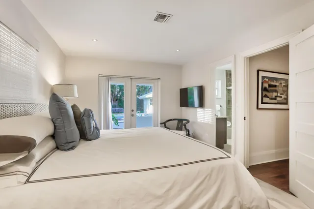 a bedroom with a large bed and a flat screen tv