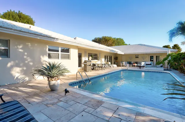 a view of a patio with chairs and potted plants