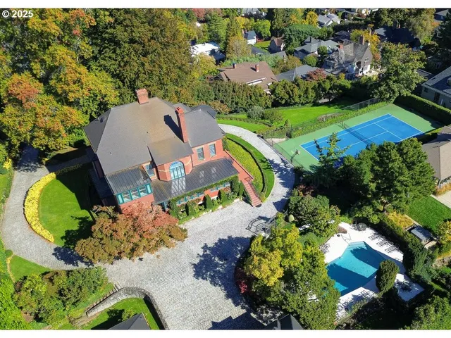 an aerial view of a house with a swimming pool yard and outdoor seating