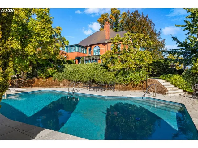a view of a house with a yard and sitting area