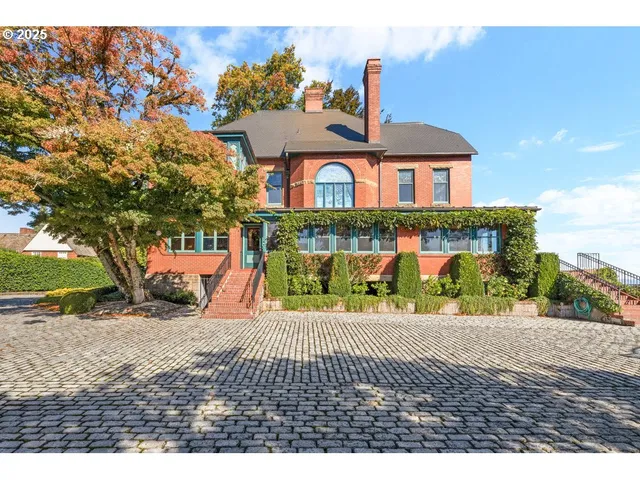 a view of a brick house with a yard