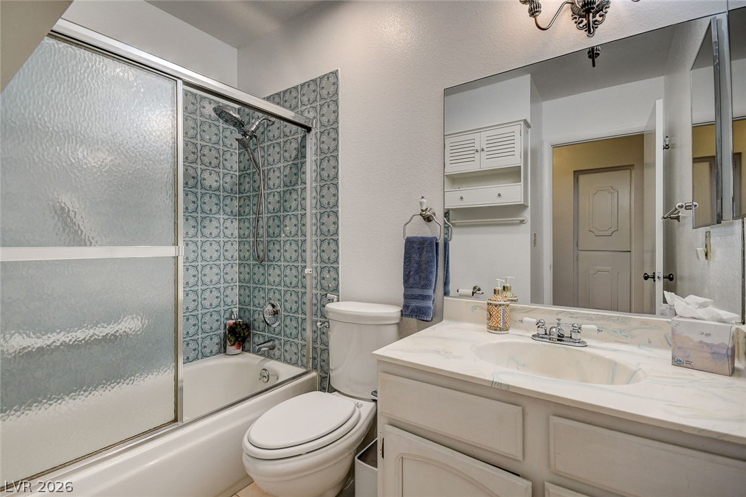 1401 Sharon Road Las Vegas, NV 89106 - Photo 52 of 73 Patterned shower tile and a classic single vanity define this well-appointed bathroom space.