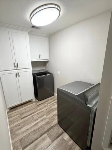 a kitchen with a refrigerator stove and cabinets