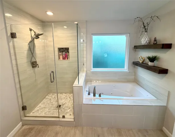 a bathroom with a tub and a shower